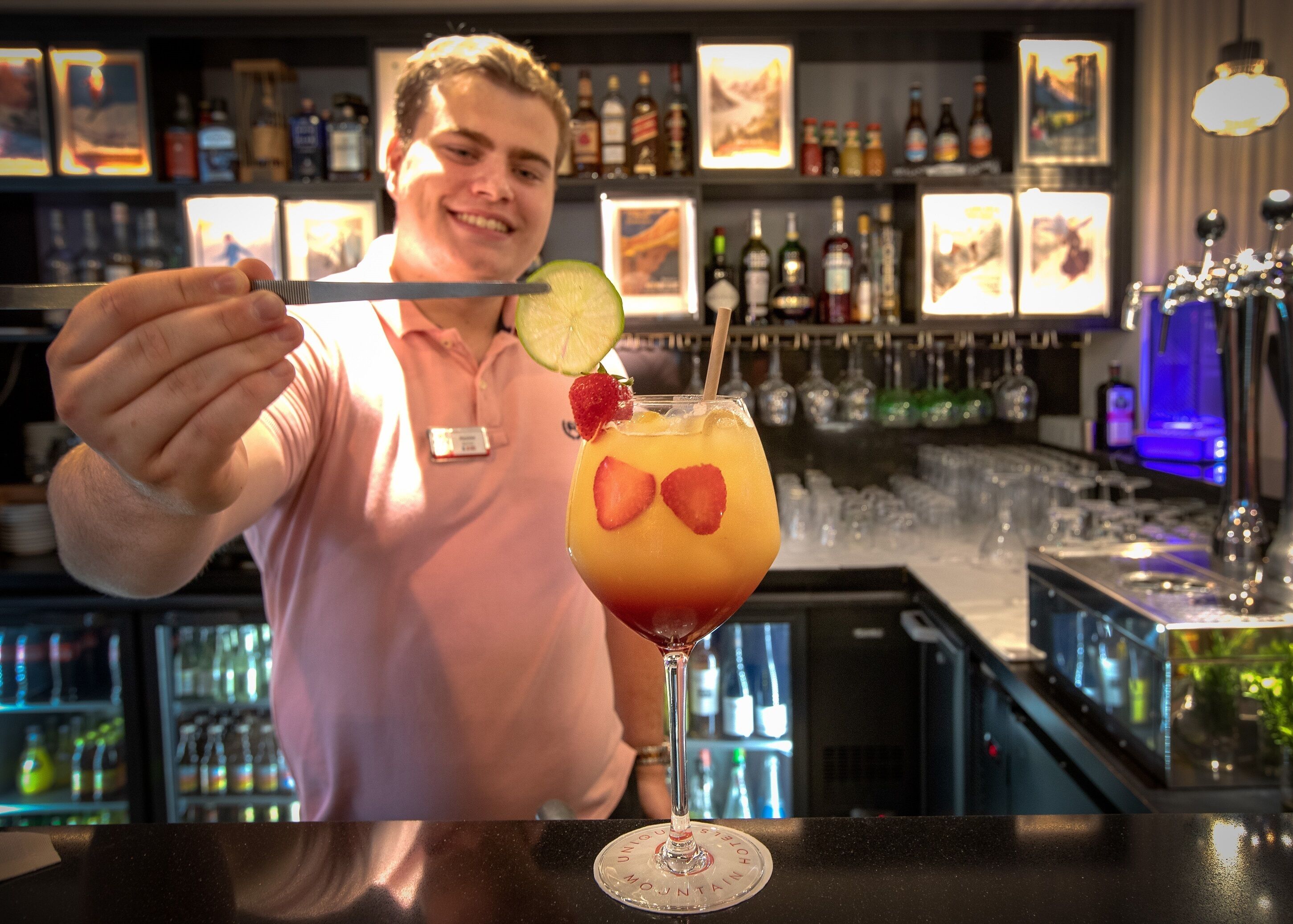Baarimikko, jolla on kädessään cocktail-sekoitin.