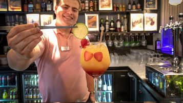 A bartender holding a cocktail shaker.