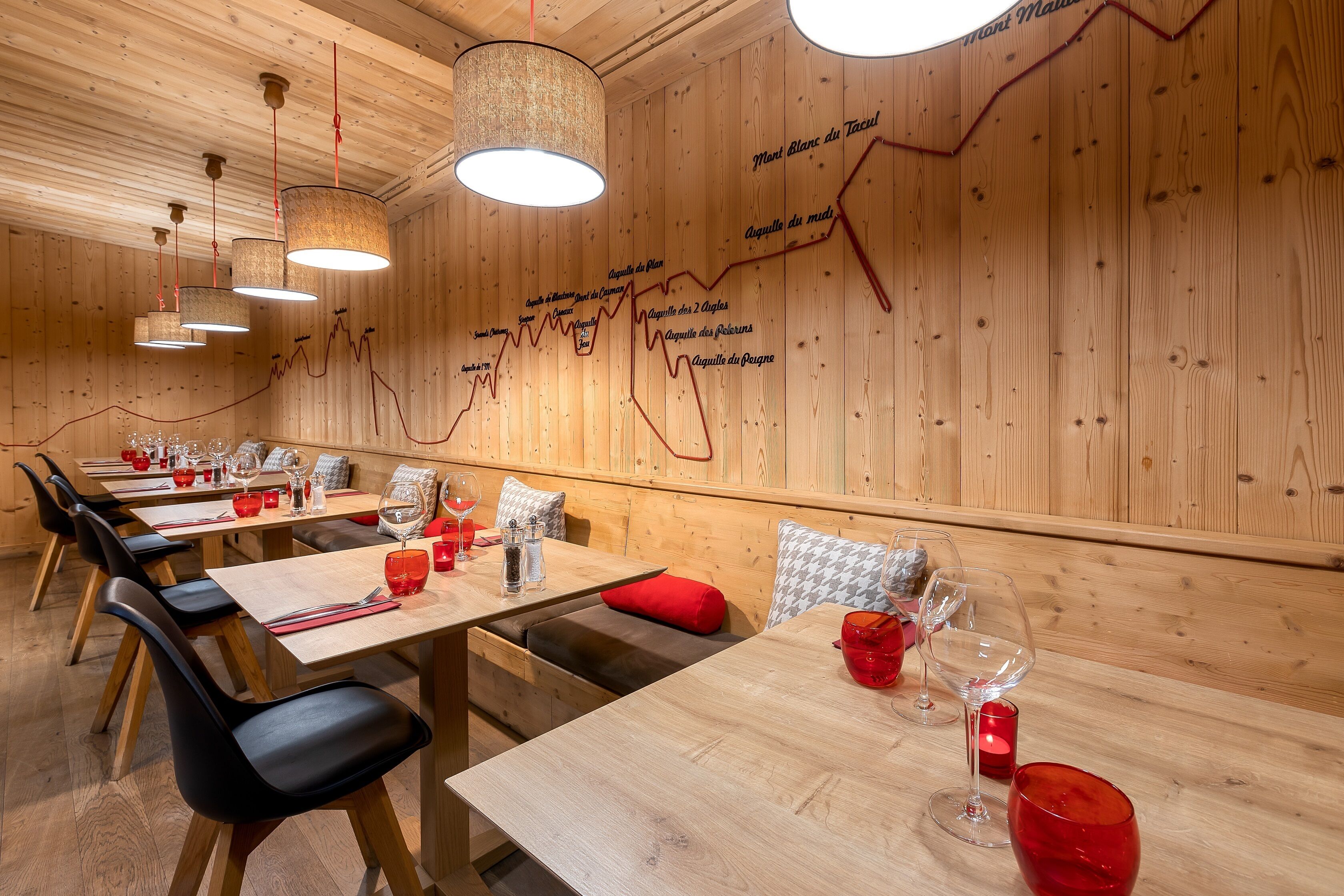 A restaurant with wooden walls and tables set for dining.
