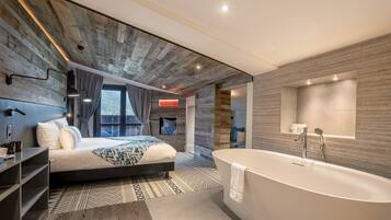A modern bedroom with a large bed, a bathtub, and a view of the outdoors.
