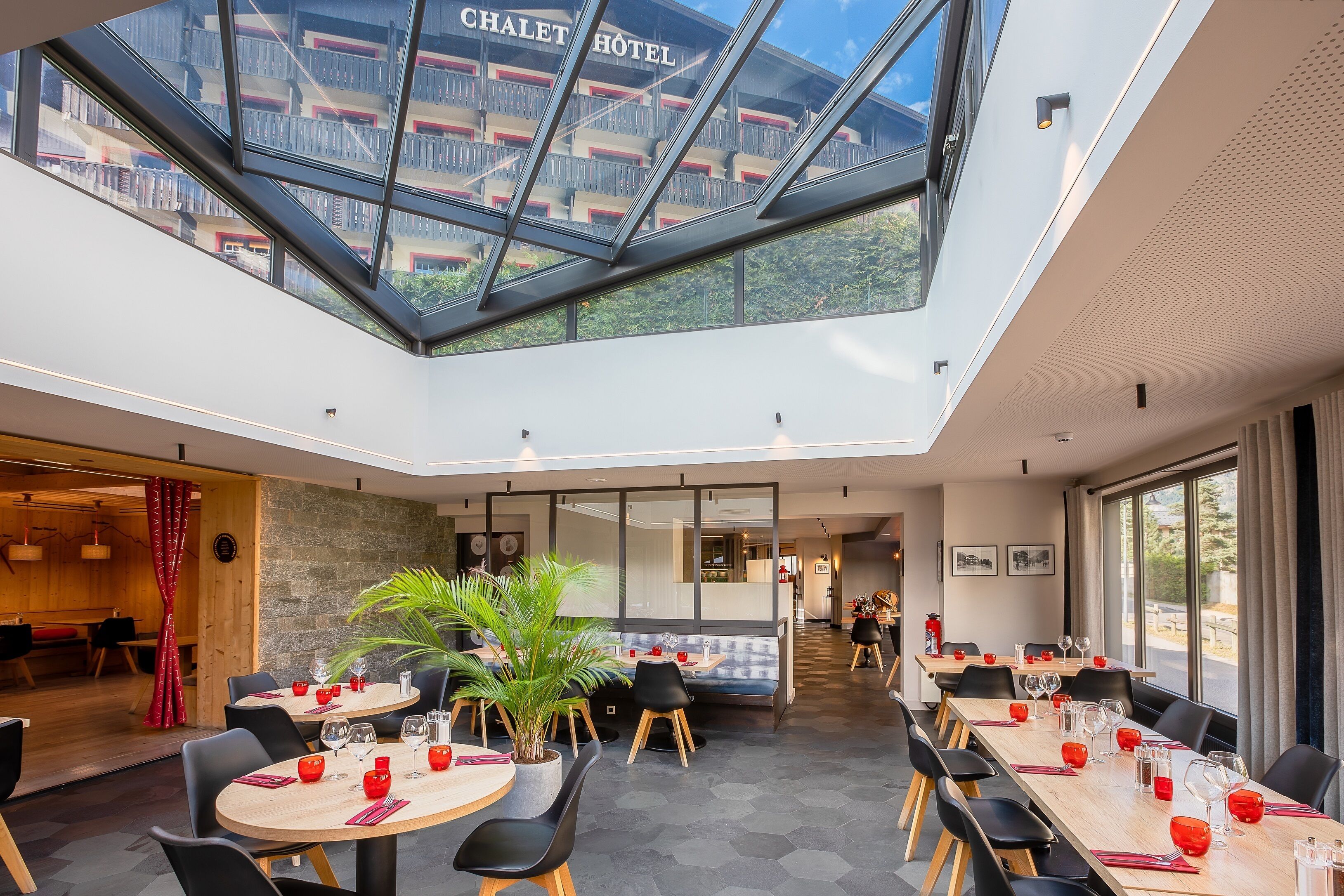Een moderne hotel lobby met een hoge plafond, een glazen atrium en een uitzicht op het hotelgebouw.