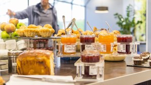 A breakfast buffet with pastries, jams, and apples. - Novotel Le Mans (Le Mans)