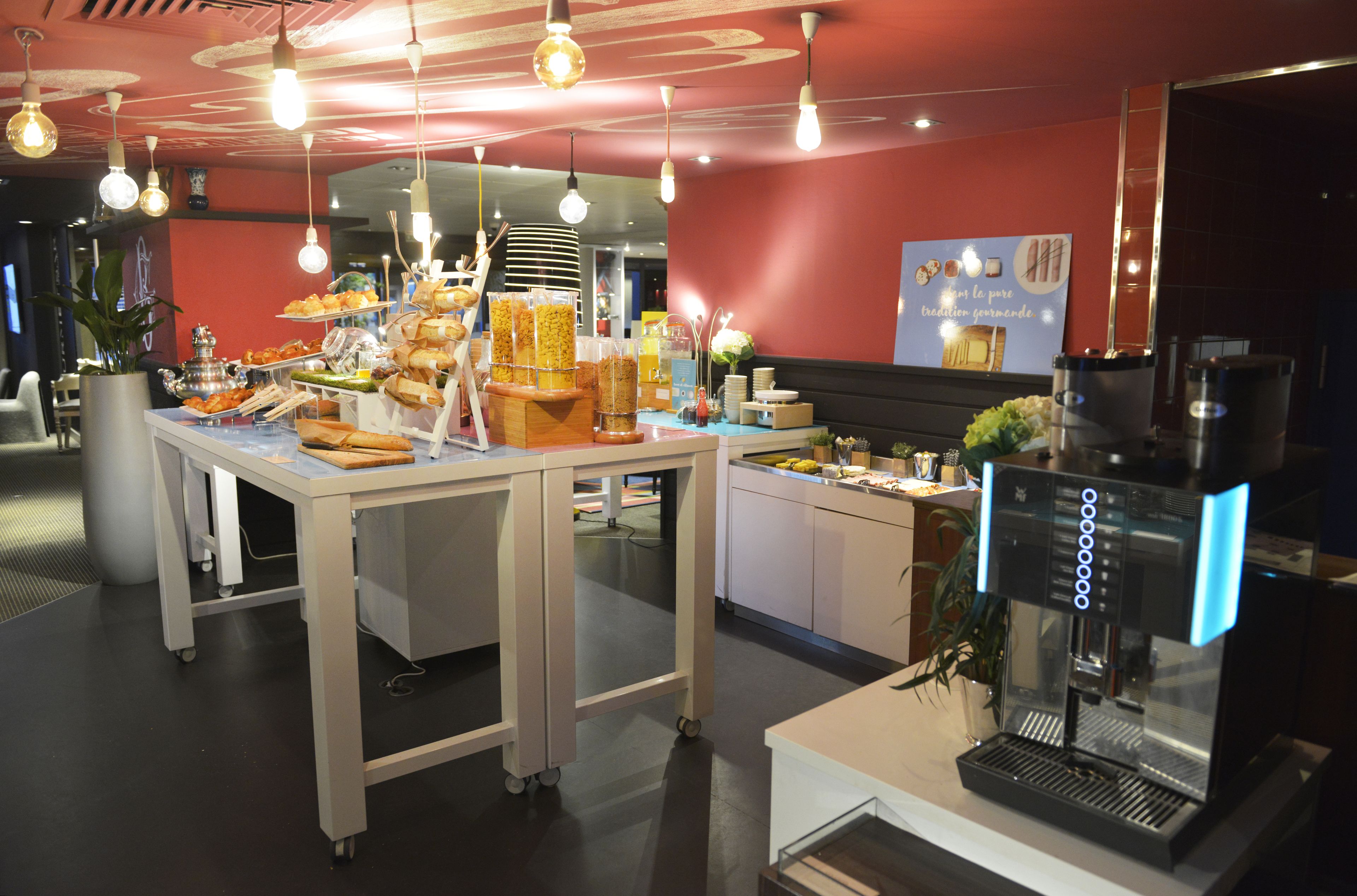 A buffet setup with various food items and a coffee machine.