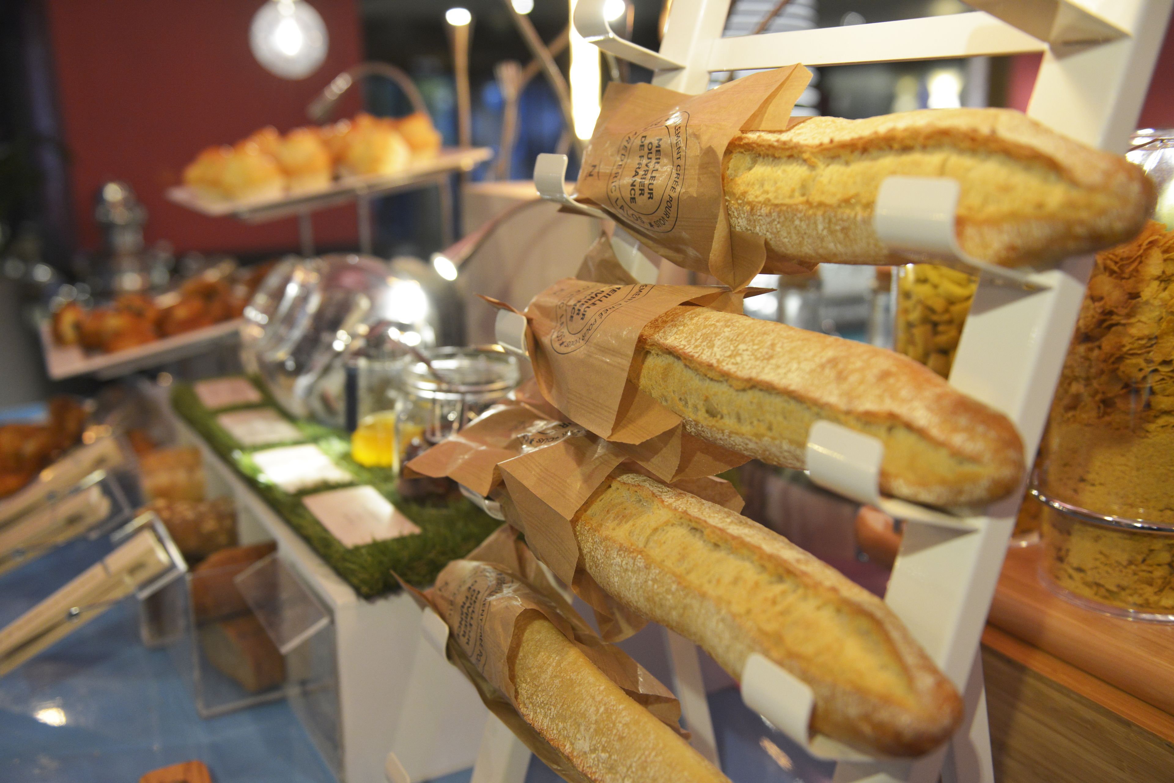 A display of baguettes in a bakery setting.