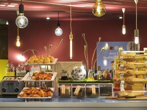 A bakery display with various baked goods and a toaster.