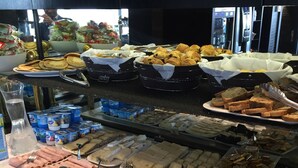 A buffet with a variety of food items including meats, cheeses, fruits, and salads. - Hôtel Cannes Centre Univers (Cannes)