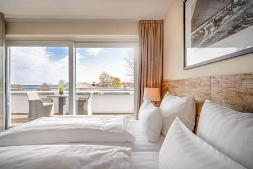 Roba de llit hipoal·lergògena, minibar i caixa forta a l'habitació