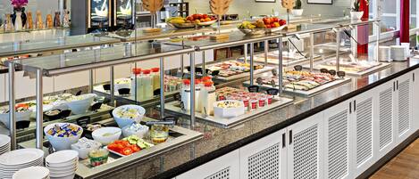 A buffet area with various food options, including fruits, vegetables, and dairy products.