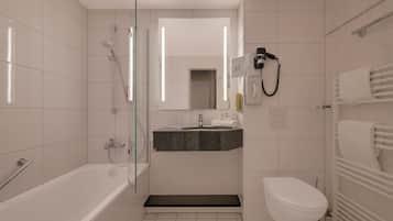 A modern bathroom with a glass-enclosed shower, a vanity with a sink, and a toilet.