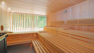 A sauna with wooden benches and a sloped ceiling.
