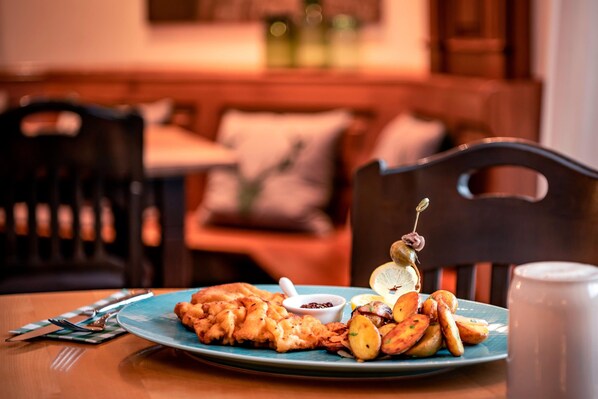 A dining table with a plate of food, a cup, and a fork. - The Westin Grand Munich (Munich)
