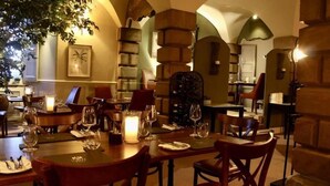 A restaurant with wooden tables and chairs, candle centerpieces, and a warm ambiance. - Lumley Castle Hotel (Chester-le-Street)