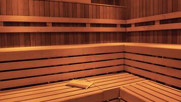 A sauna with wooden benches and a book placed on one of them.