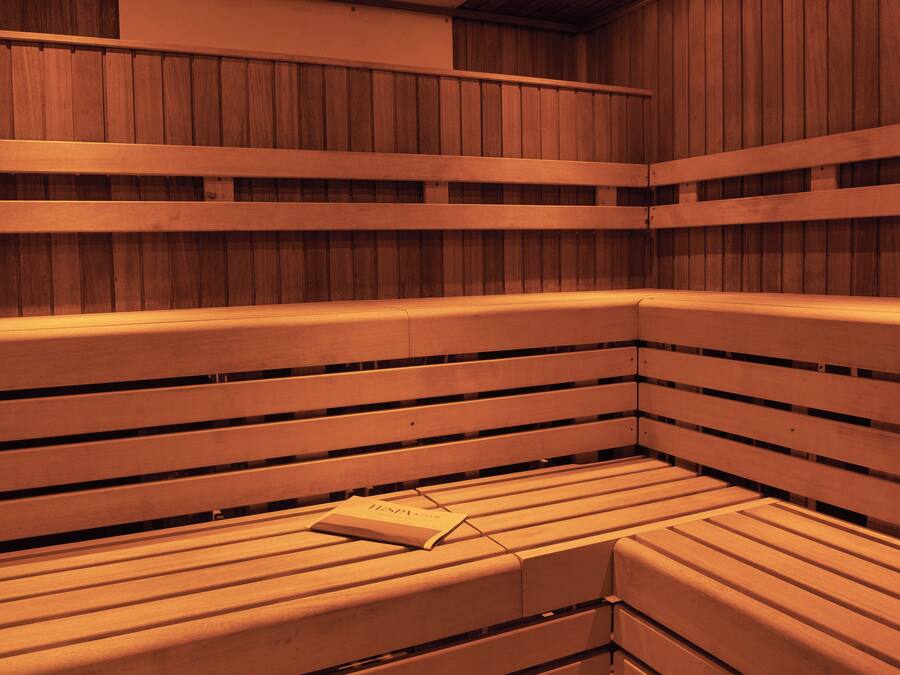 A sauna with wooden benches and a book placed on one of them.