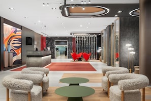 A modern hotel lobby with a reception desk, seating area, and decorative lighting. - Hotel Erzsébet City Center Budapest, a member of Radisson Individuals (Budapest)