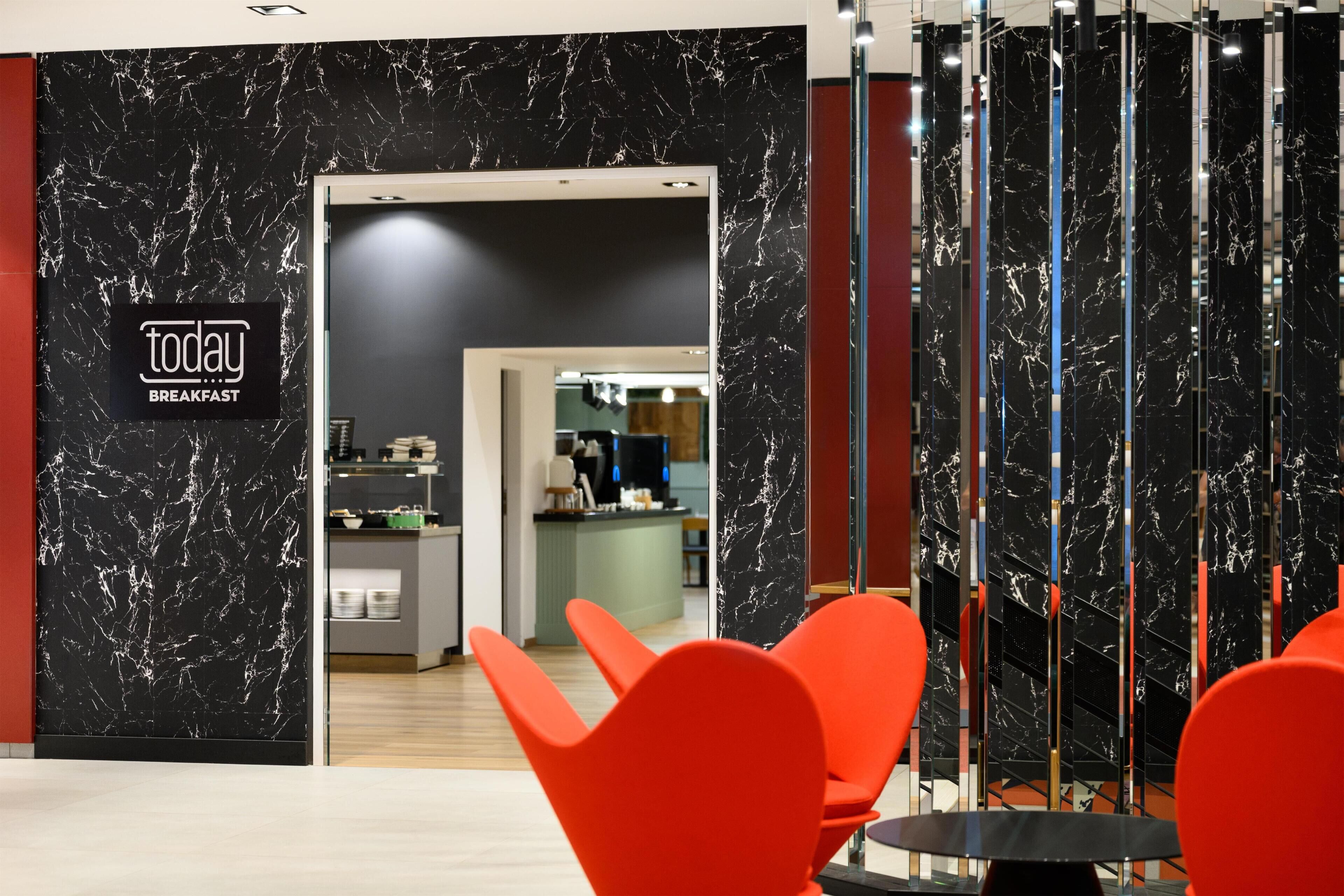 A modern breakfast area with a marble wall and a sign reading 'today... BREAKFAST'.