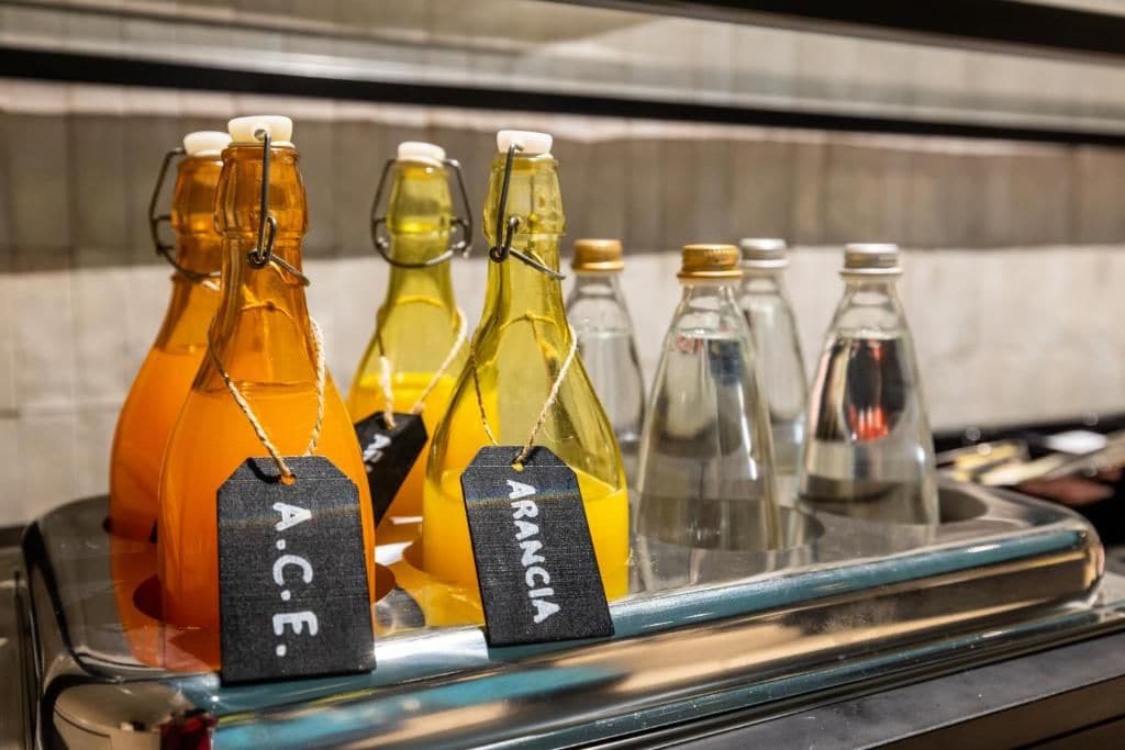 A selection of bottled beverages with labels, arranged on a shelf.