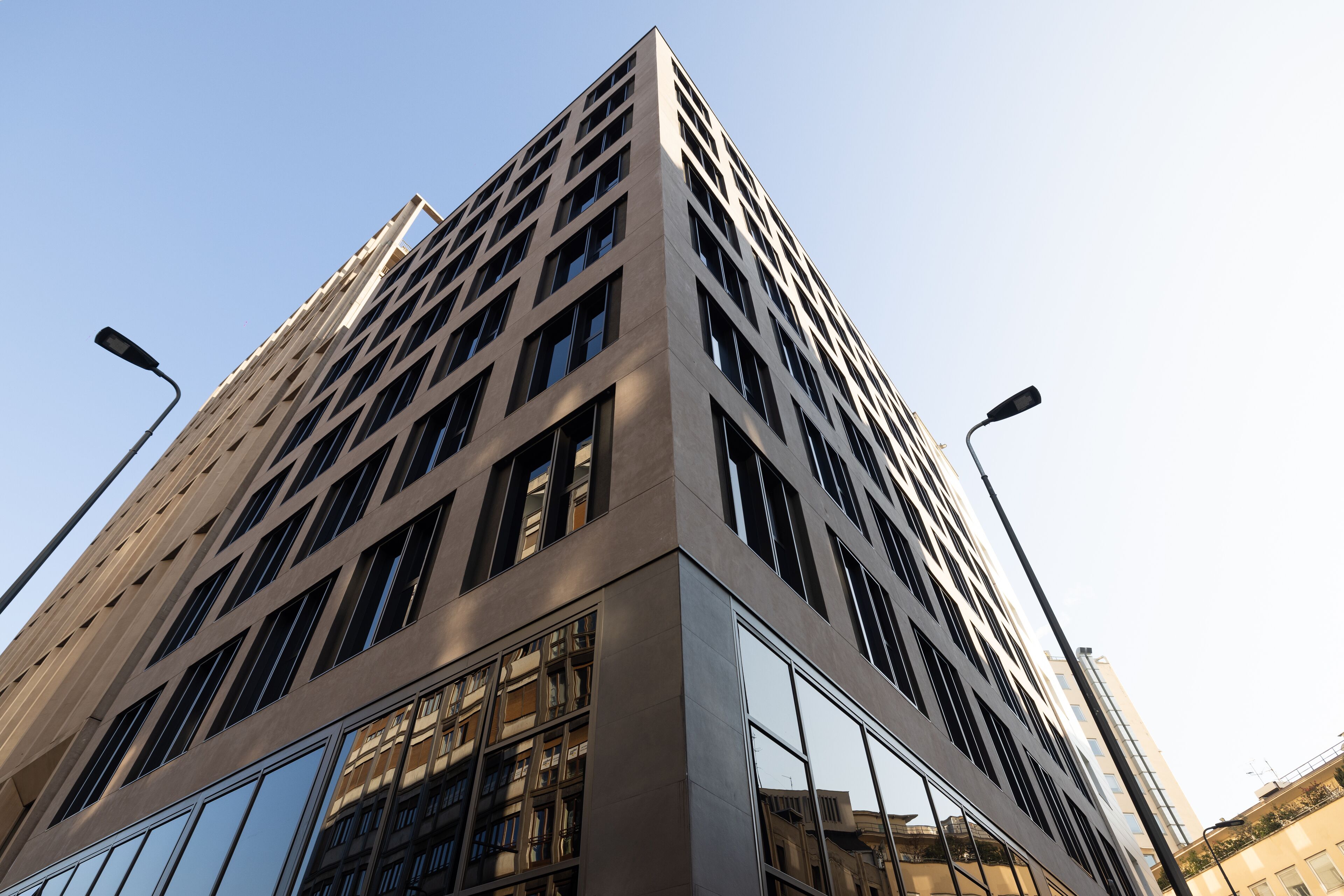 A tall, modern building with a grid-like facade and large windows.