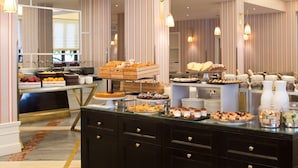 A buffet with various food items and a modern interior design.
