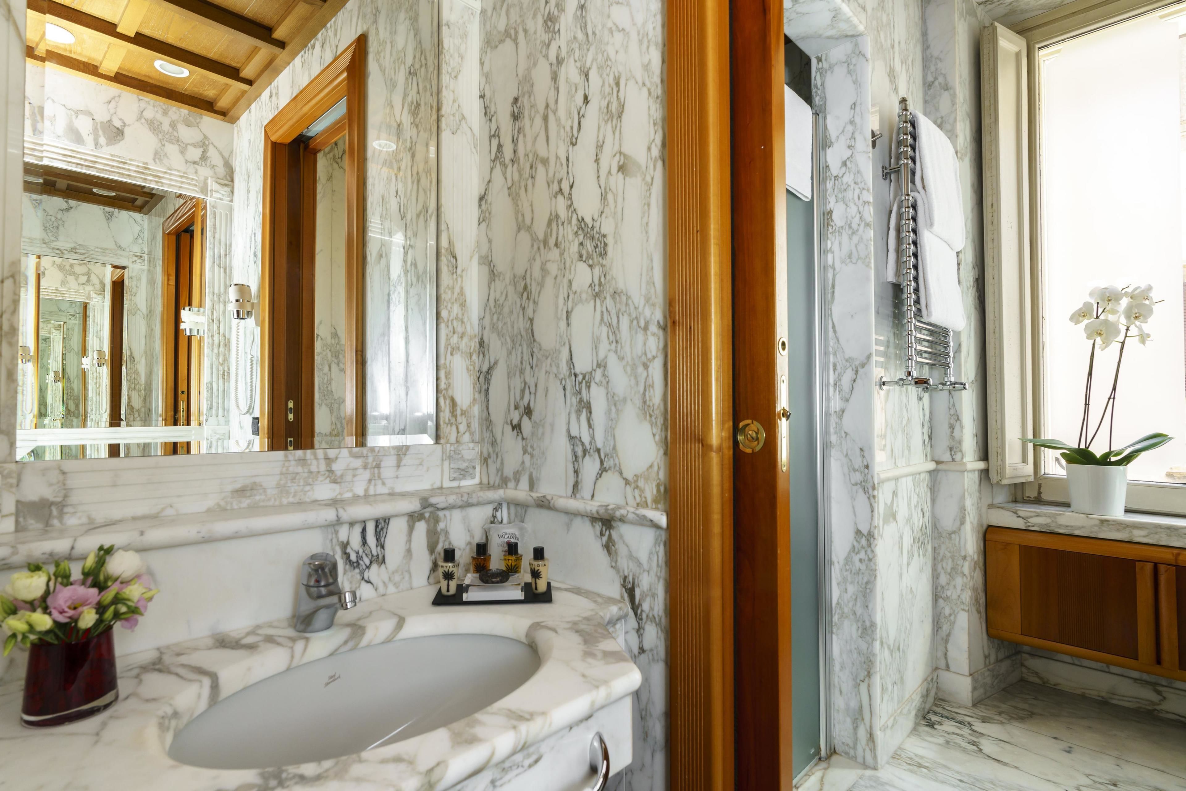 junior suite | bathroom | deep-soaking bathtub, rainfall showerhead, bidet, towels