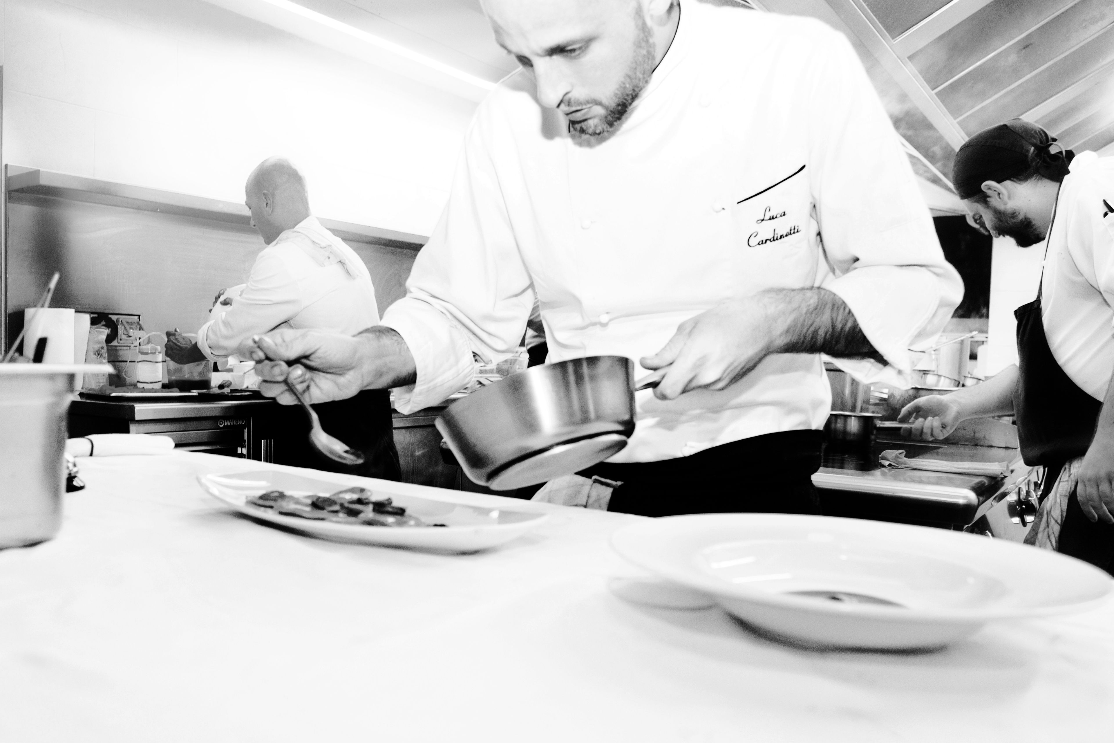 A professional kitchen with chefs preparing food.