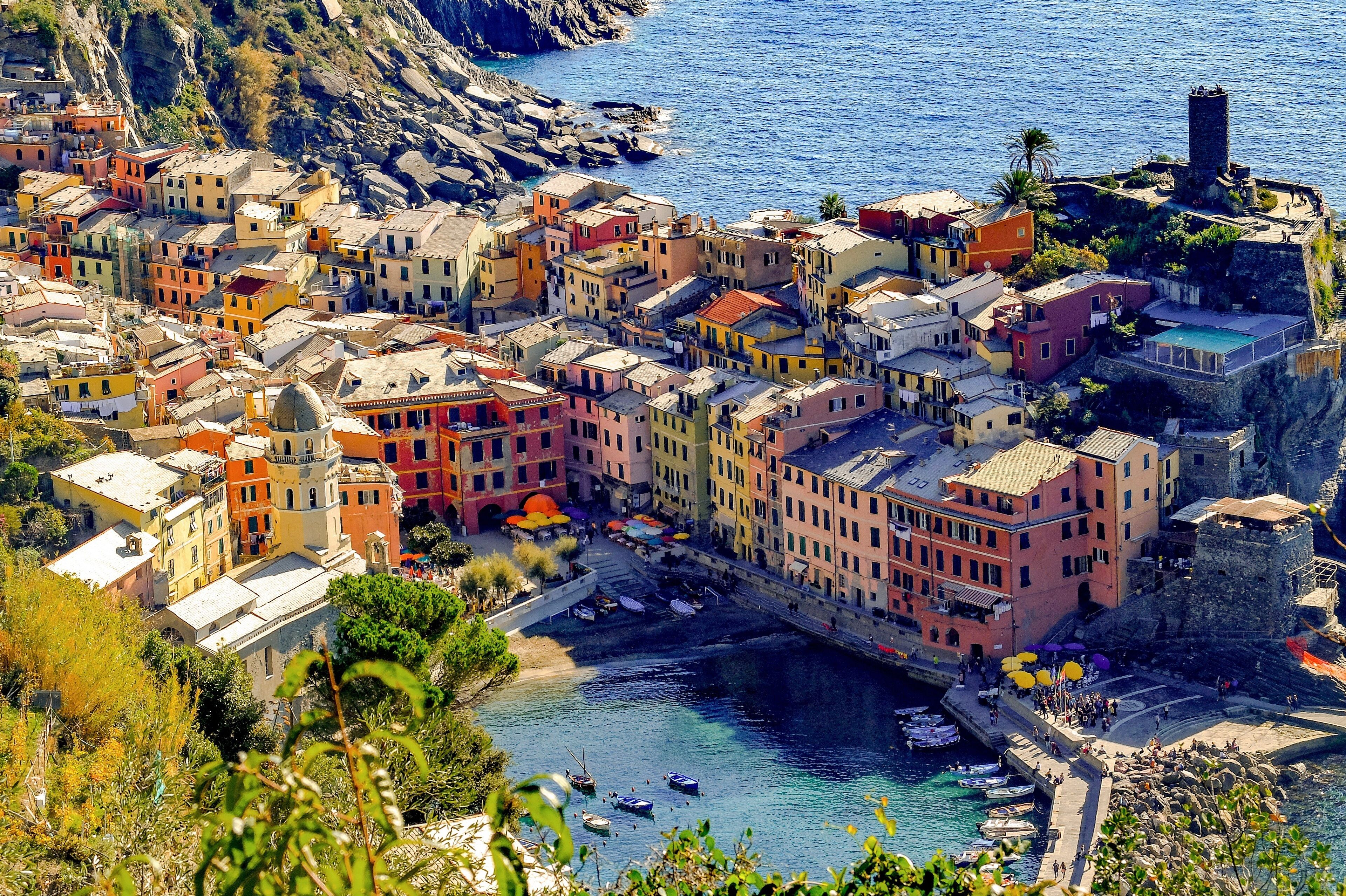 A coastal town with colorful buildings, a river, and boats.