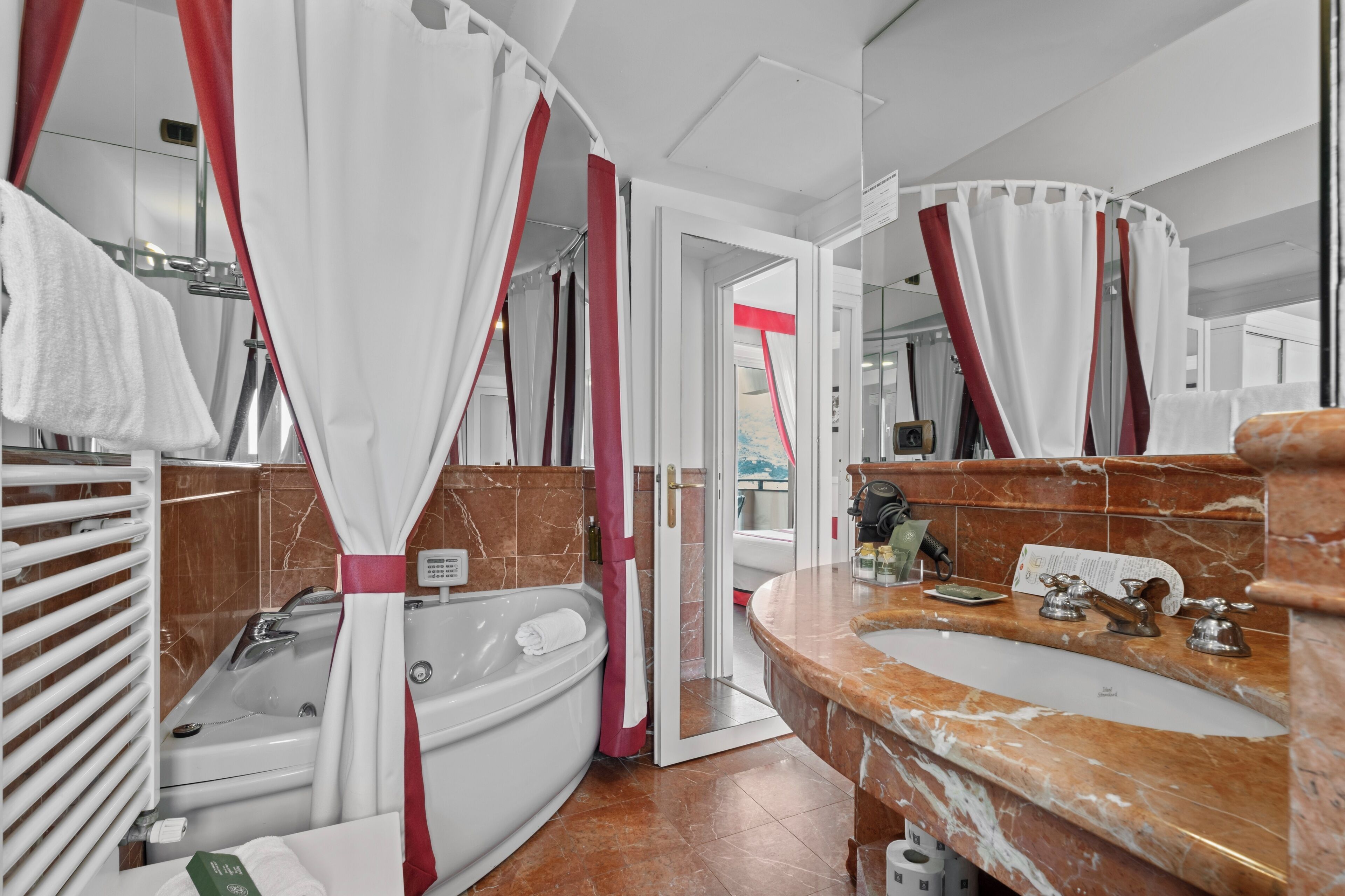 A bathroom with a bathtub, a sink, and a shower curtain.