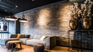 A modern living room with a sectional sofa, round coffee table, and decorative vases.