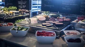 A buffet with various food items and a chalkboard menu listing dishes like 'Brunoski' and 'Ovnsbakt Leverpostei'.
