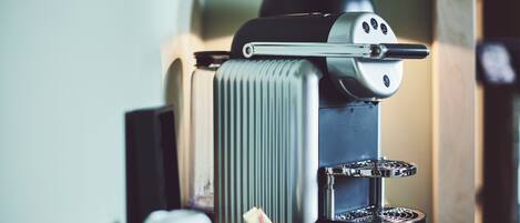 A coffee machine with a water reservoir and a drip tray.
