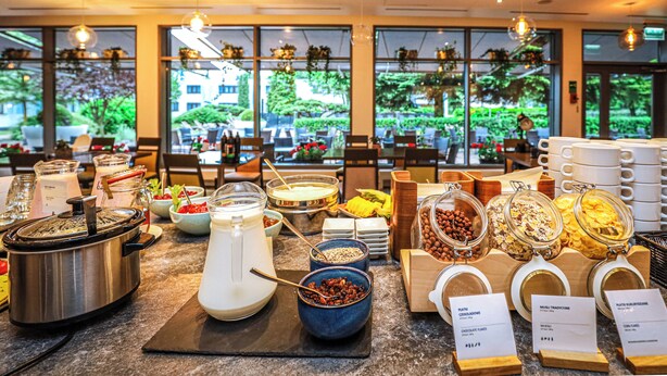 A buffet with various food items and a coffee station.