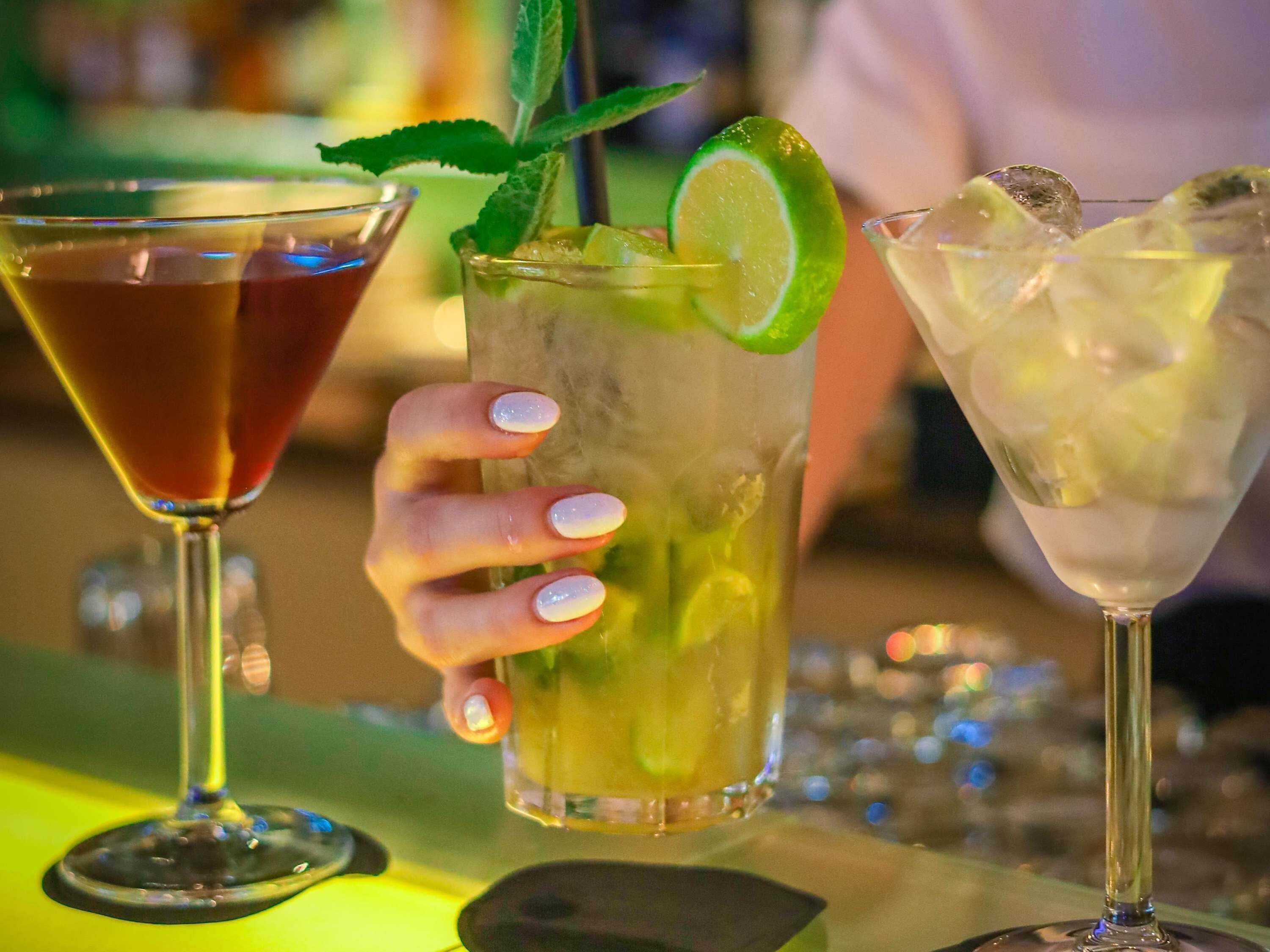 Three cocktails in different glasses.