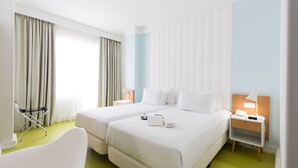 A hotel room with two beds, a chair, a nightstand, and a lamp. - Legendary Porto Hotel (Porto)