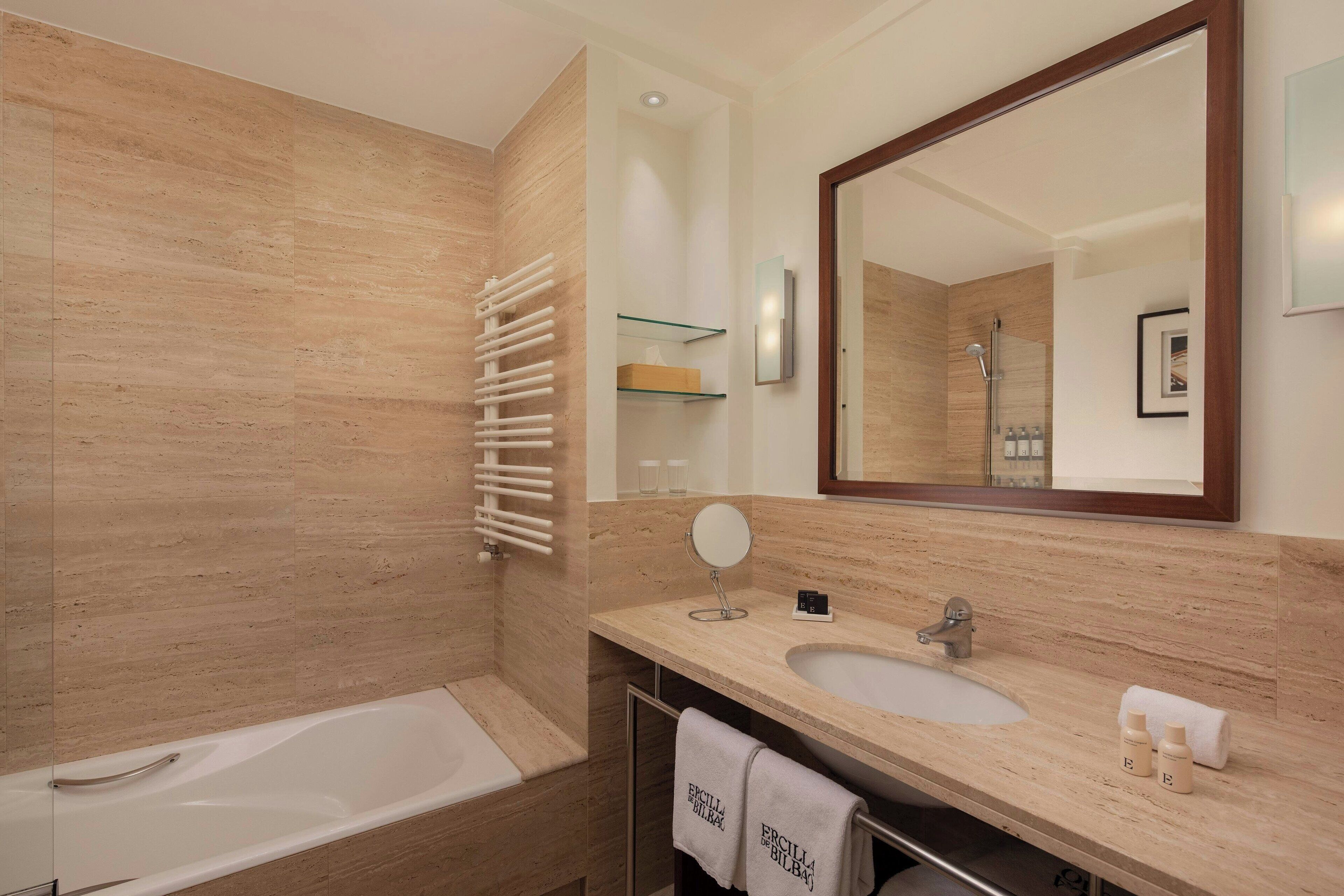 separate bathtub and shower, hair dryer, towels