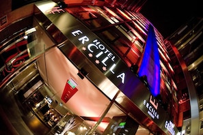A hotel with a modern design, featuring a prominent sign with the name 'Hotel Ercilla'.