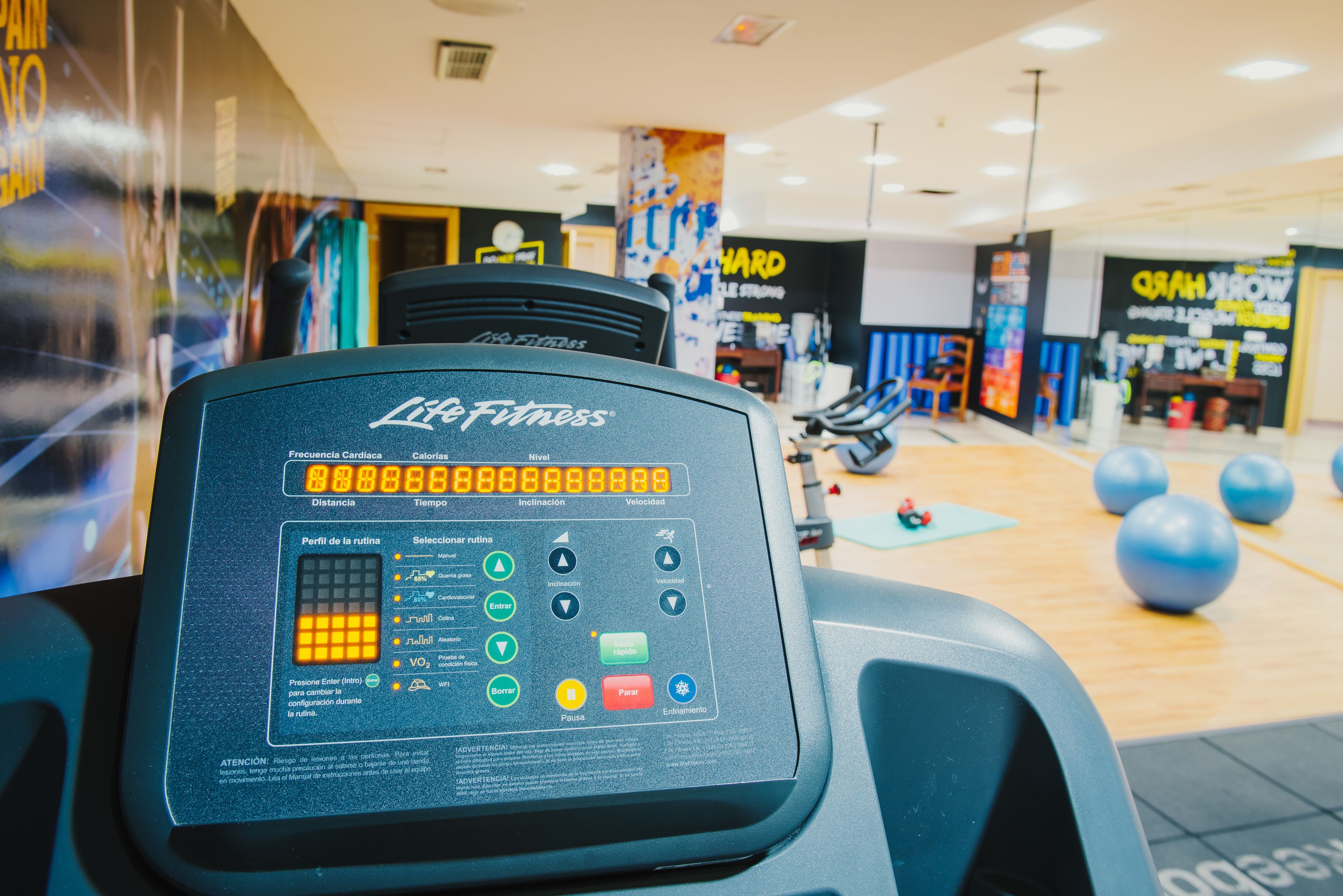 A gym equipment control panel with various settings and indicators.