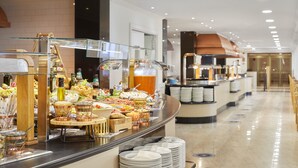 A buffet area with various food items and beverages, a coffee station, and a counter with a cash register. - Sol Pelícanos Ocas (Benidorm)