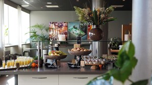 A buffet setup with various food items and a decorative centerpiece.