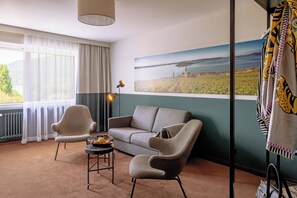 Junior Room, Courtyard View | Living area | 95-cm TV with cable channels