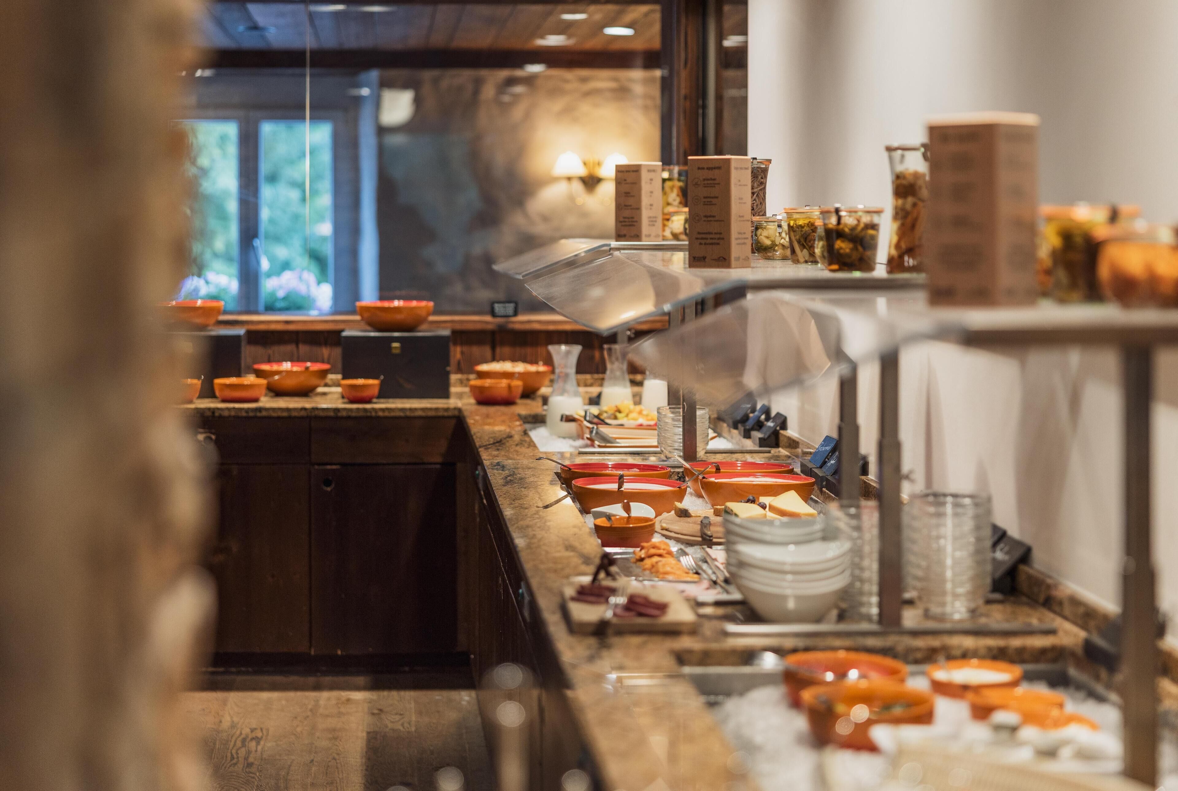 A buffet setup with various food items and containers.