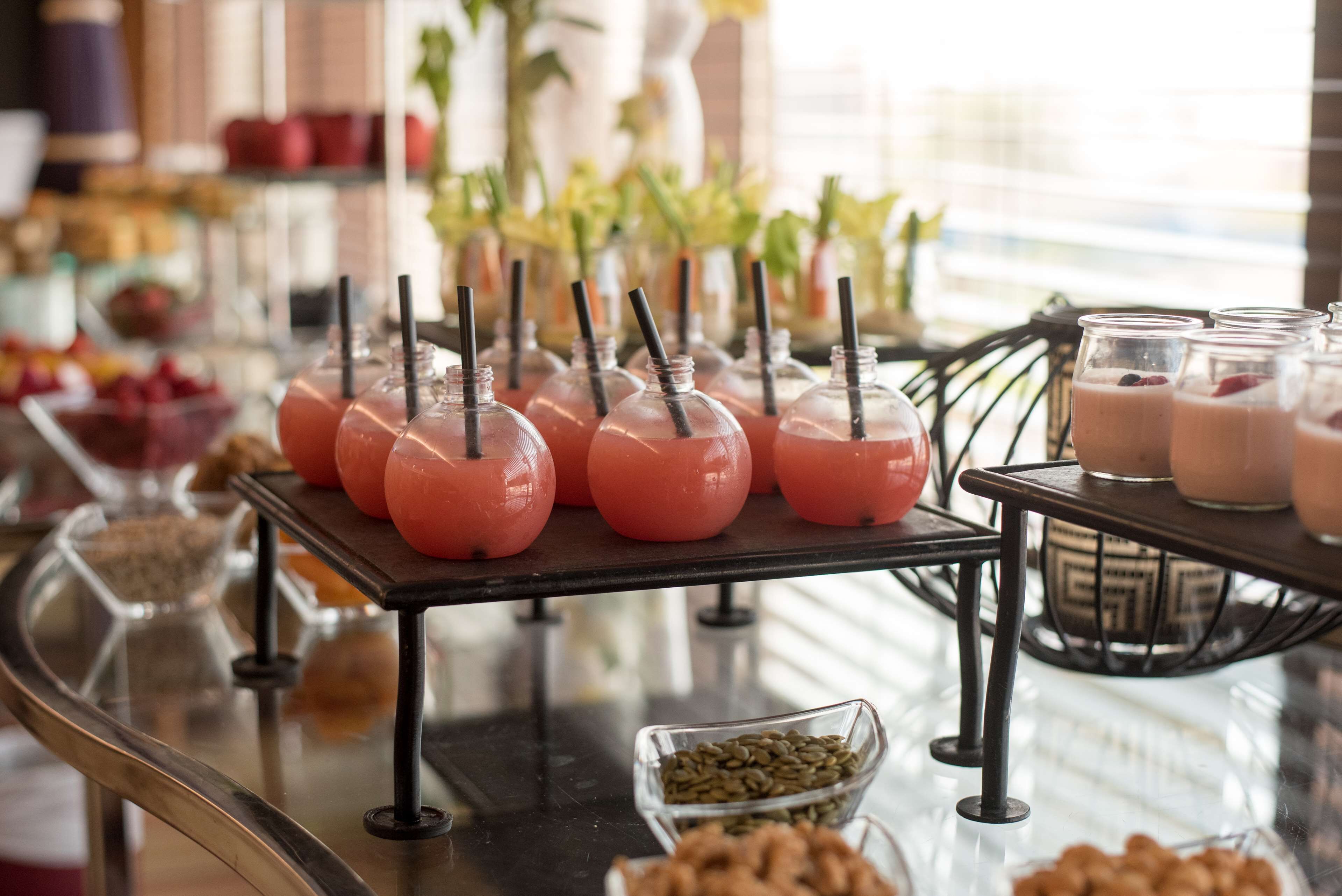 A buffet table with various food items and drinks.