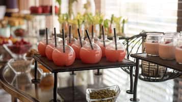 A buffet table with various food items and drinks.