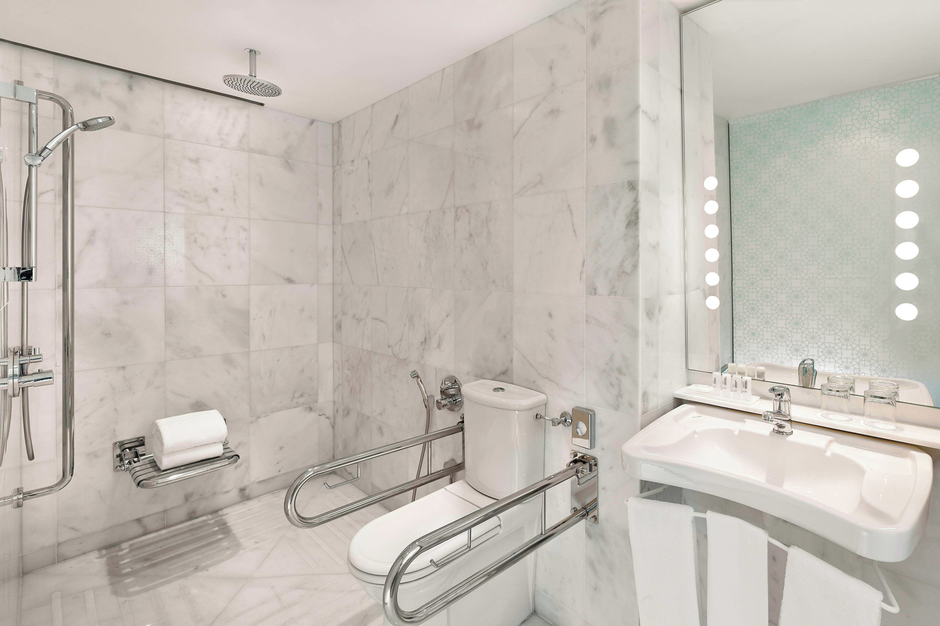 deluxe room, 1 king bed, non smoking, sea view | bathroom | free toiletries, hair dryer, bathrobes, slippers