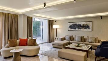 Una sala moderna con un sofá modular, una mesa de centro redonda y una lámpara de pie.