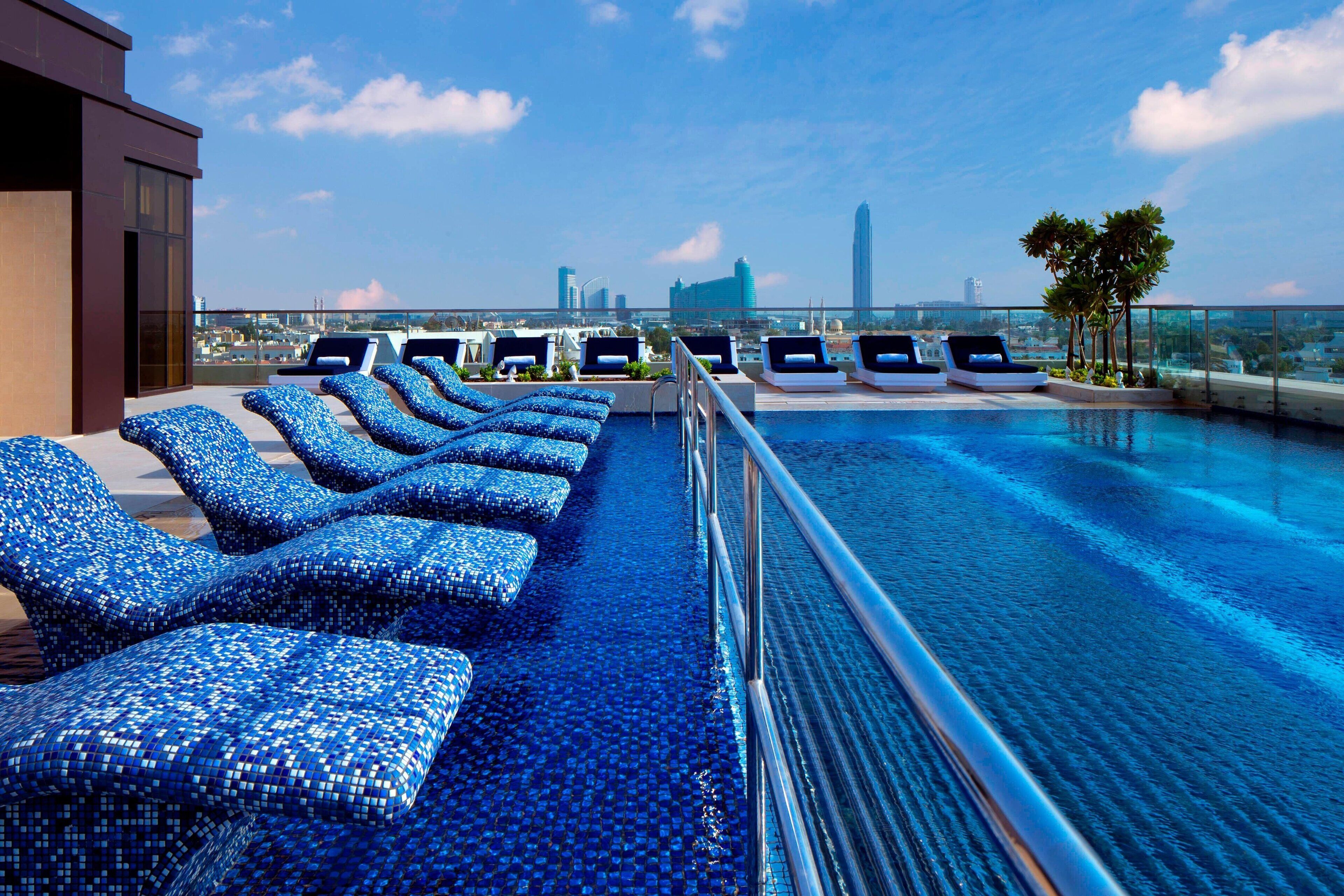 5 outdoor pools, open 5:30 AM to 10:00 PM, pool umbrellas, pool loungers