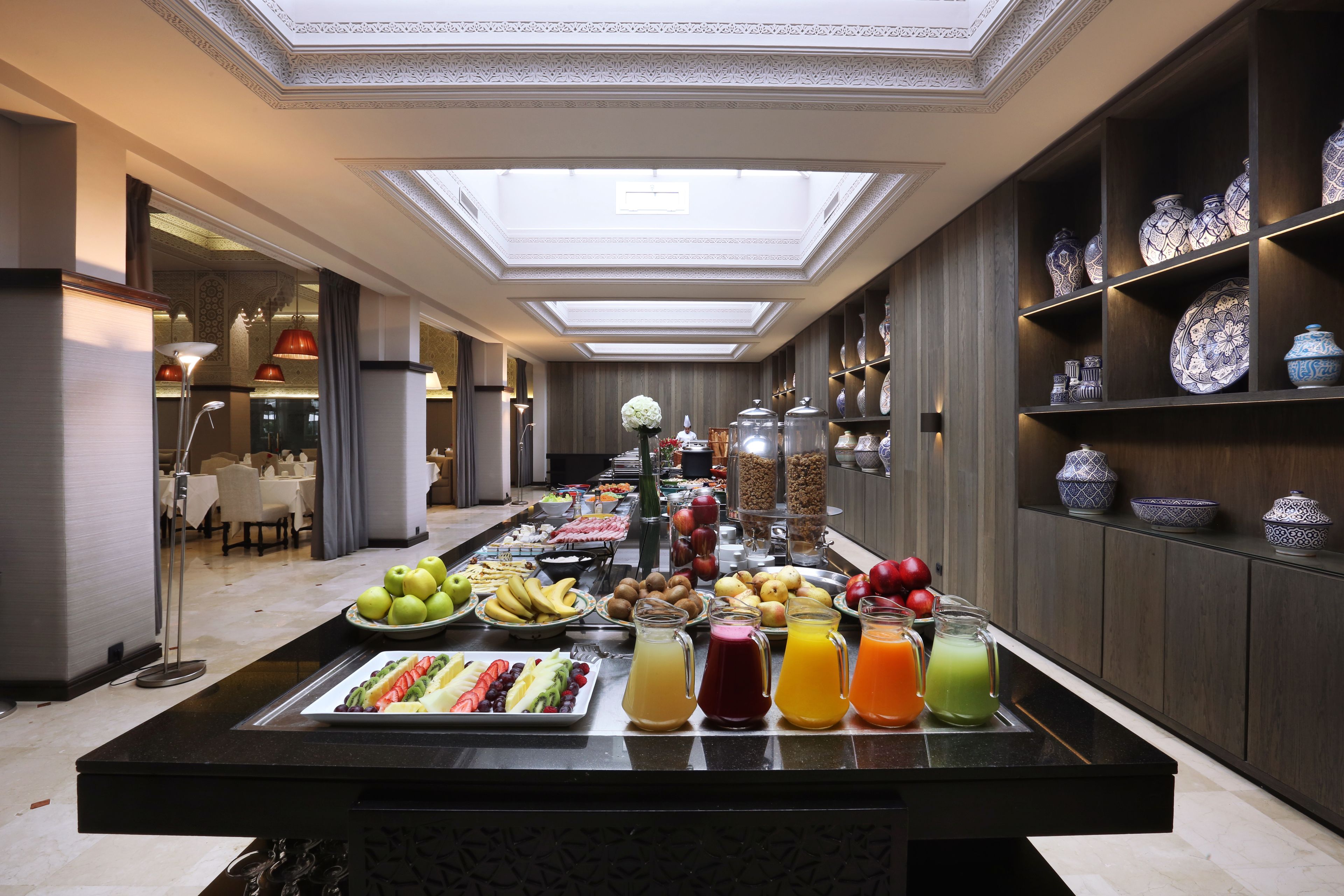 A breakfast buffet with a variety of fruits, vegetables, and beverages.