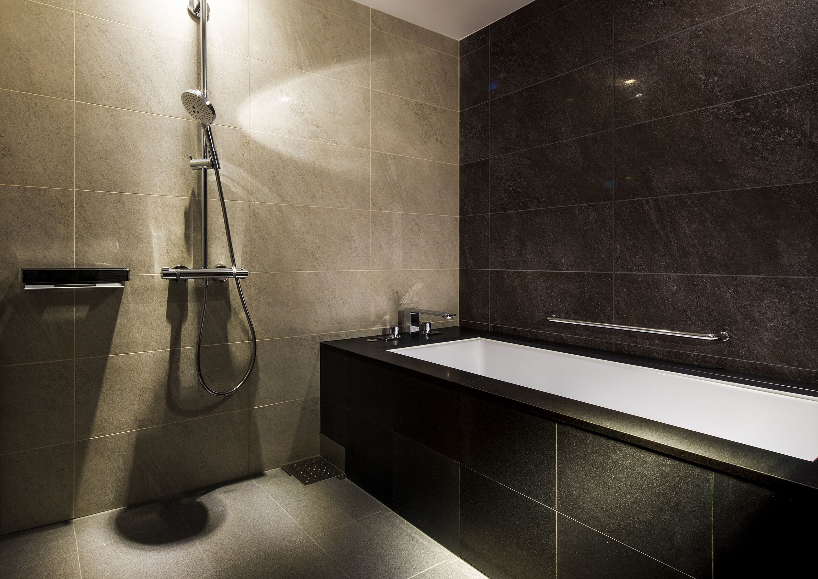 A modern bathroom with a shower, a sink, and a vanity.