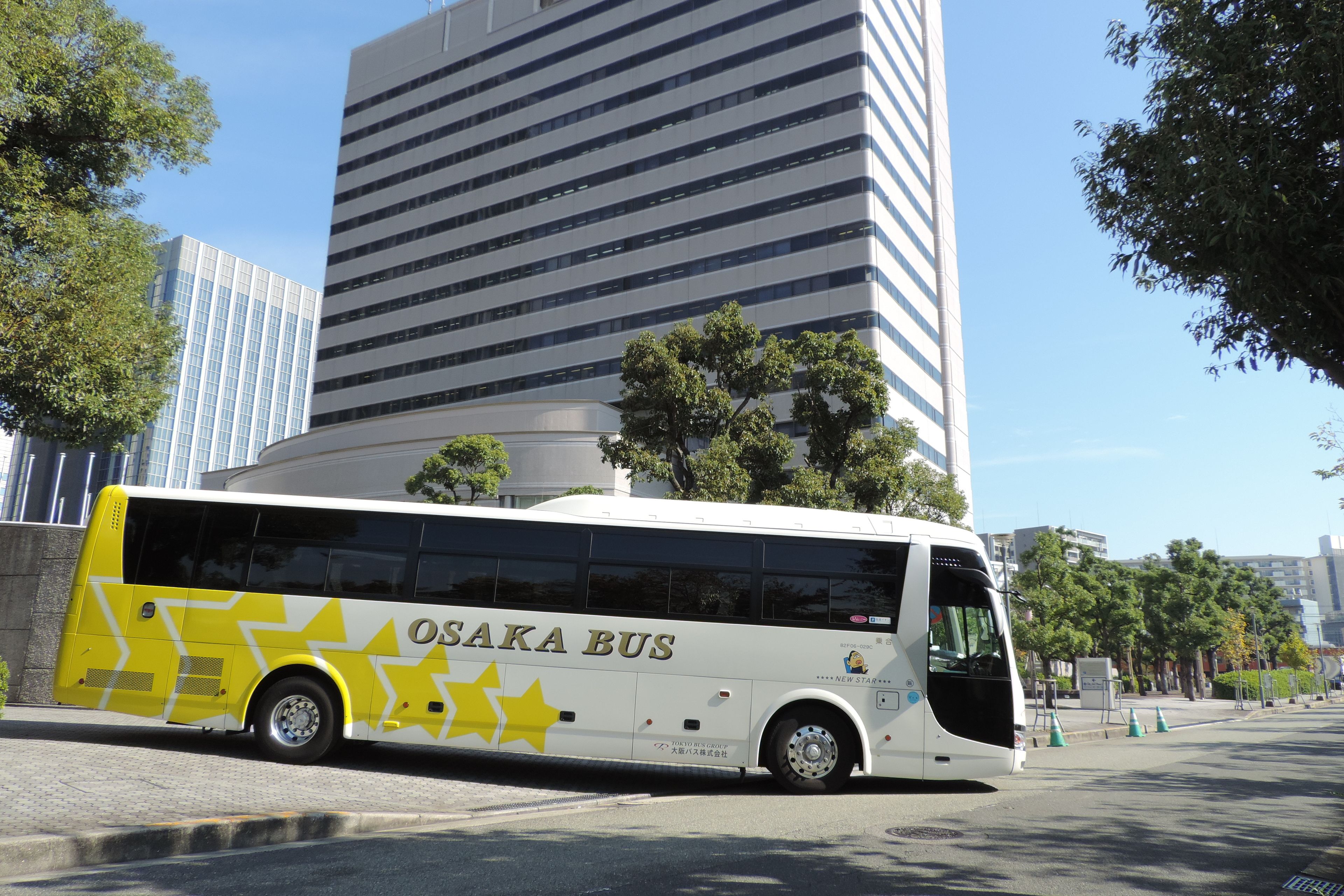 A modern bus with "OSAKA BUS" branding parked on a city street.