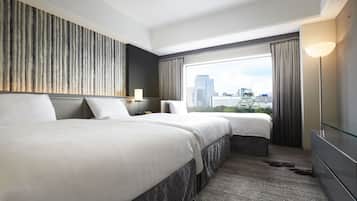 A hotel room with two beds, a large window with a city view, a modern lamp, and a flat-screen TV.