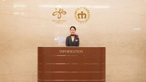 A reception desk with a marble wall background, a logo, and the text "INFORMATION". - Hotel New Hankyu Osaka (Osaka)